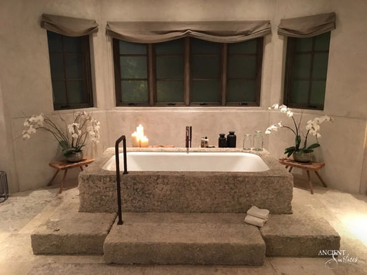 reclaimed_antique_stone_tub_marble_limestone_freestanding_bathtub_hand_carved_soaking_tub_luxury_bath_ancient_surfaces_historic_stonebath_sculpted_stone_tub_custom_carved_marble_bathtub_reclaimed_limestone_tub_old_world_bath_design_classic_european_stone_tub_high_end_bathroom_feature_luxury_interior_design_artisanal_stonework_antique_marble_tub_natural_stone_bath_vintage_stone_bathtub_master_bath_suite_ancient_surfaces_collection