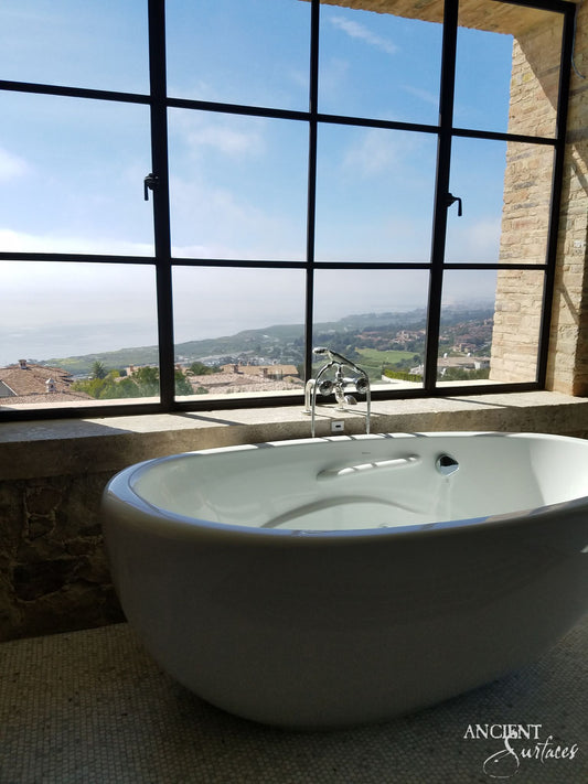 reclaimed_antique_stone_tub_marble_limestone_freestanding_bathtub_hand_carved_soaking_tub_luxury_bath_ancient_surfaces_historic_stonebath_sculpted_stone_tub_custom_carved_marble_bathtub_reclaimed_limestone_tub_old_world_bath_design_classic_european_stone_tub_high_end_bathroom_feature_luxury_interior_design_artisanal_stonework_antique_marble_tub_natural_stone_bath_vintage_stone_bathtub_master_bath_suite_ancient_surfaces_collection